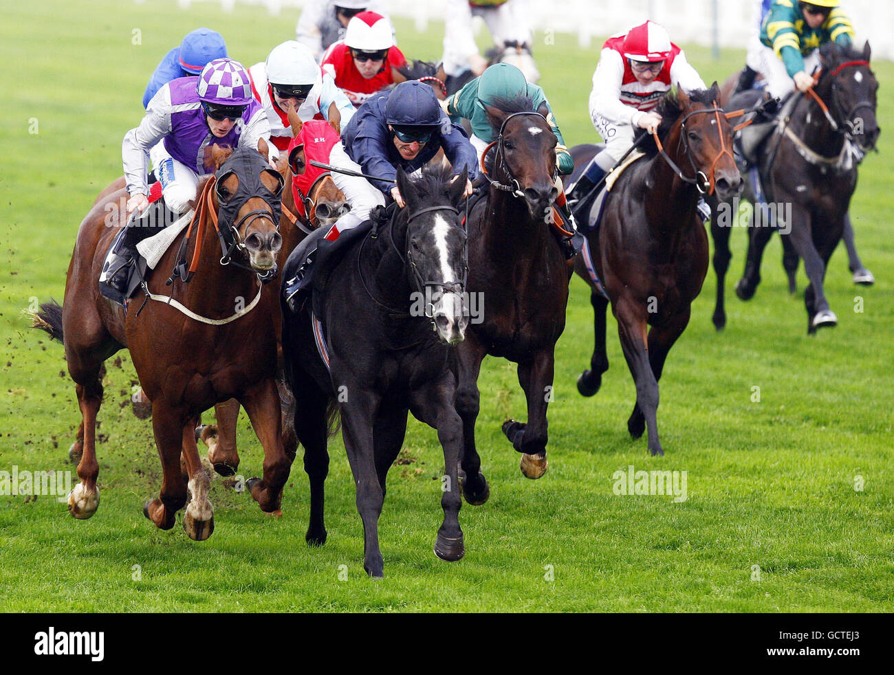 Bewitched ridden by Johnny Murtagh (centre left) rides to victory in the Models 1 Bengough Stakes at Ascot Racecourse. Stock Photo