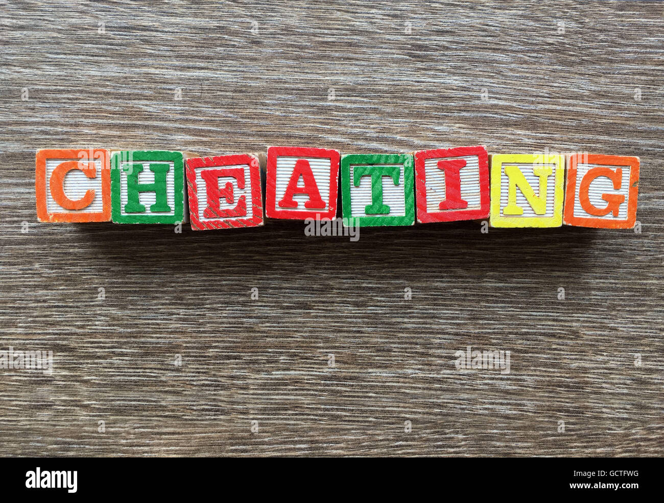 CHEATING word written with wood block letter toys Stock Photo