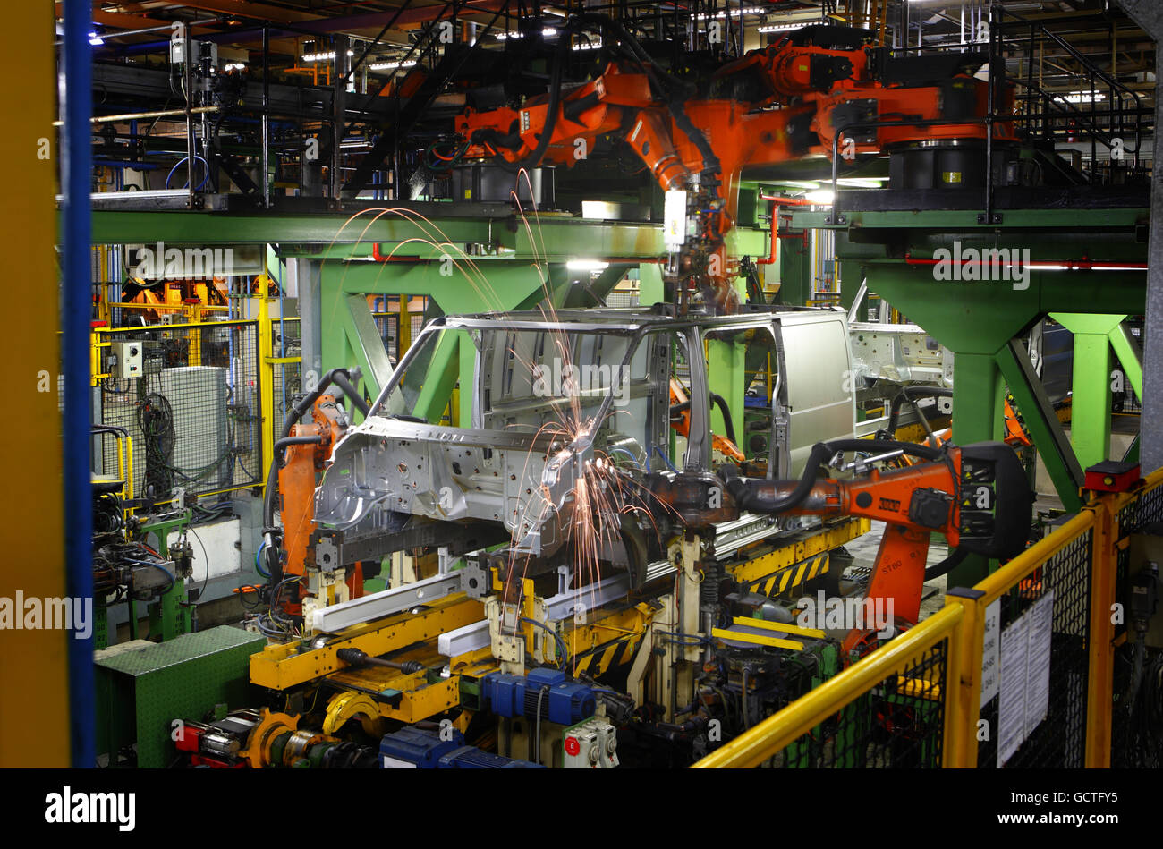Robots weld a Transit van together at the Ford factory in Southampton, Hampshire where 125 vans roll off the production line each day. Production has halved in the last year with 500 staff being made redundant due to reduced demand in the market. However, the iconic vehicle still accounts for one in three vans sold in the UK. Stock Photo