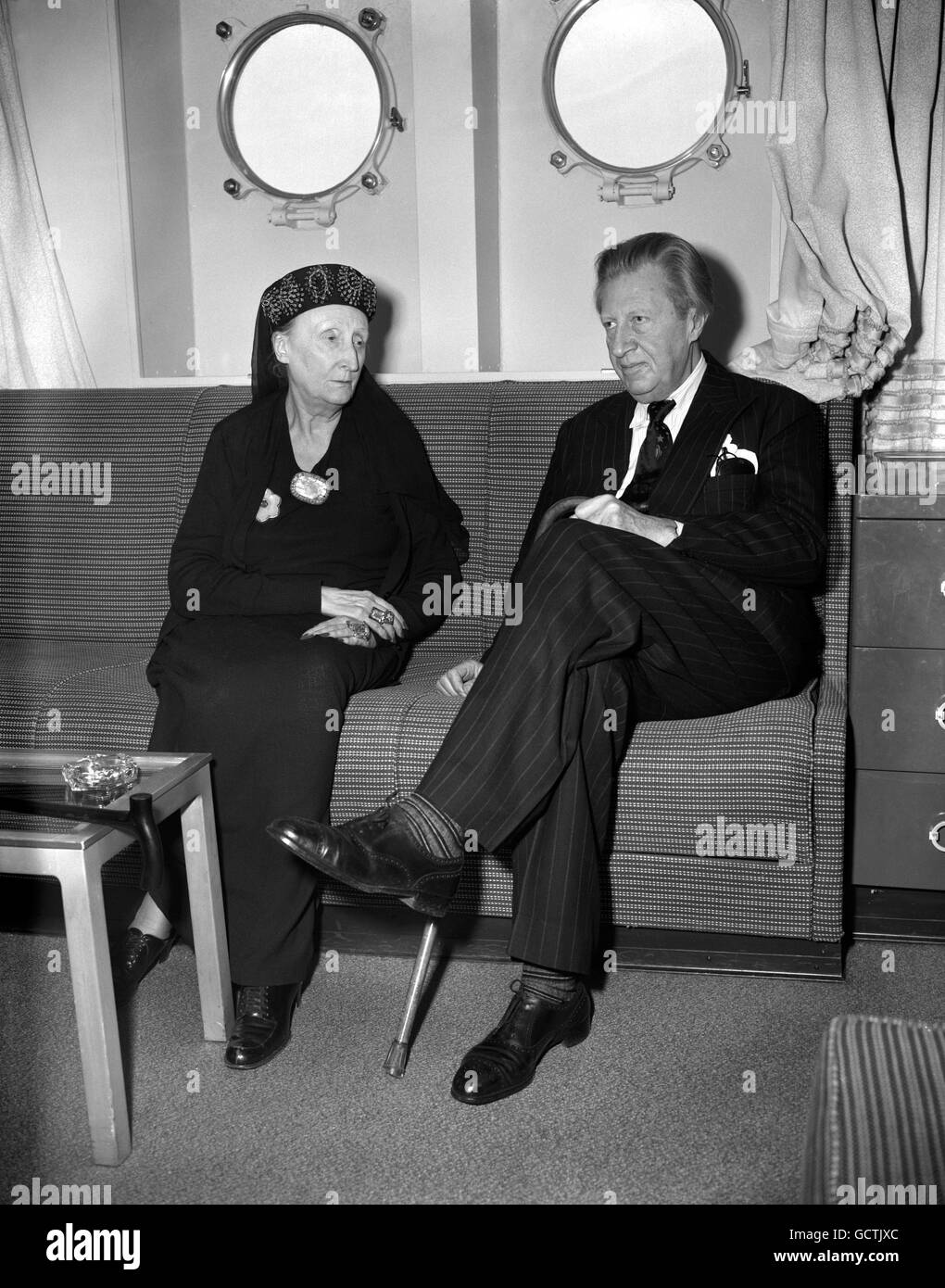Poet Sir Osbert Sitwell with his sister Dame Edith Sitwell, poet, critic, lecturer and wit, as she arrives at Southampton on aboard the liner United states from America, where she has been giving readings of her poetry. On a visit to Hollywood, Dame Edith met Marilyn Monroe, brought from the film star the comment 'I think she is one of the most wonderful women I've ever met'. Stock Photo