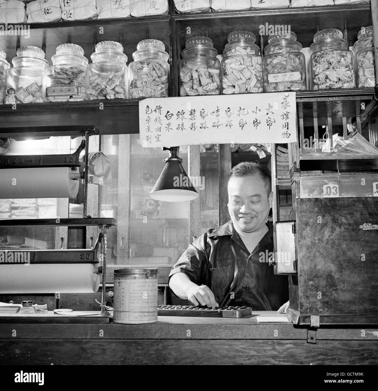 Chinese shopkeeper using an abacus in a grocery store in Chinatown, New York City, NY in 1942.  Photo by Marjory Collins, US Farm Security Administration. Stock Photo