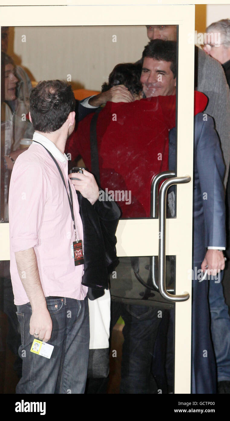 Simon Cowell hugs Harry Styles of One Direction as he leaves after this