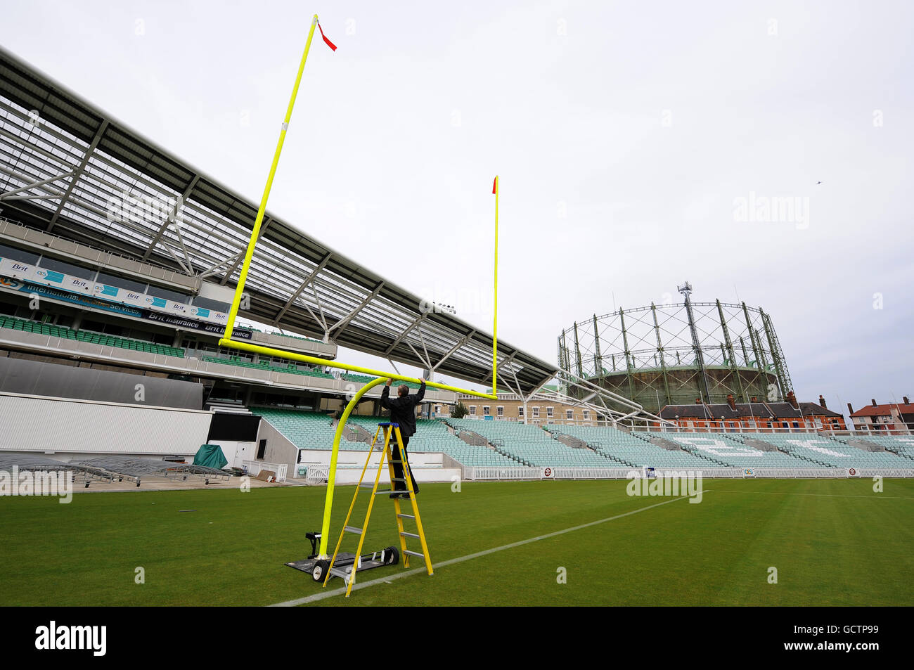 A groundsman prepares an American Football goal on the pitch at the Brit Insurance Oval Stock Photo