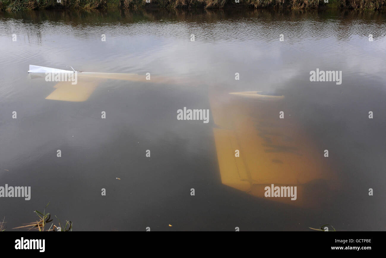 A two seater Robin 2160 light aircraft upside-down in the River Derwent, near the village of Aughton in East Yorkshire. Stock Photo