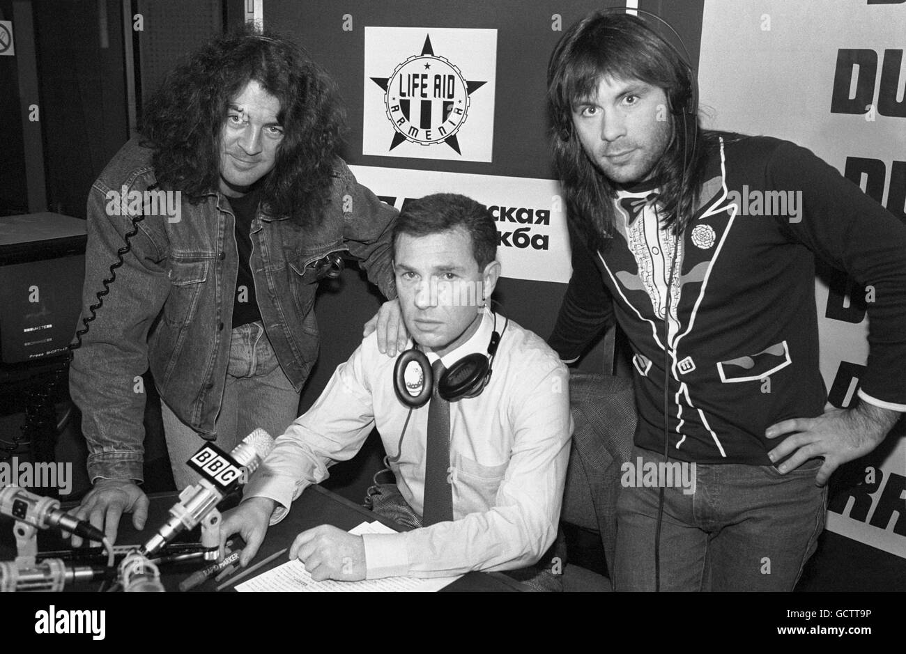 Heavy metal rock stars Ian Gillan, left, (formerly of Deep Purple) and Bruce Dickinson, right, of Iron Maiden, with disc jockey Sam Yossman, centre, at the BBC Studios, London. The BBC's Russian Service is holding a phone-in where USSR rock fans can talk to the stars. Stock Photo