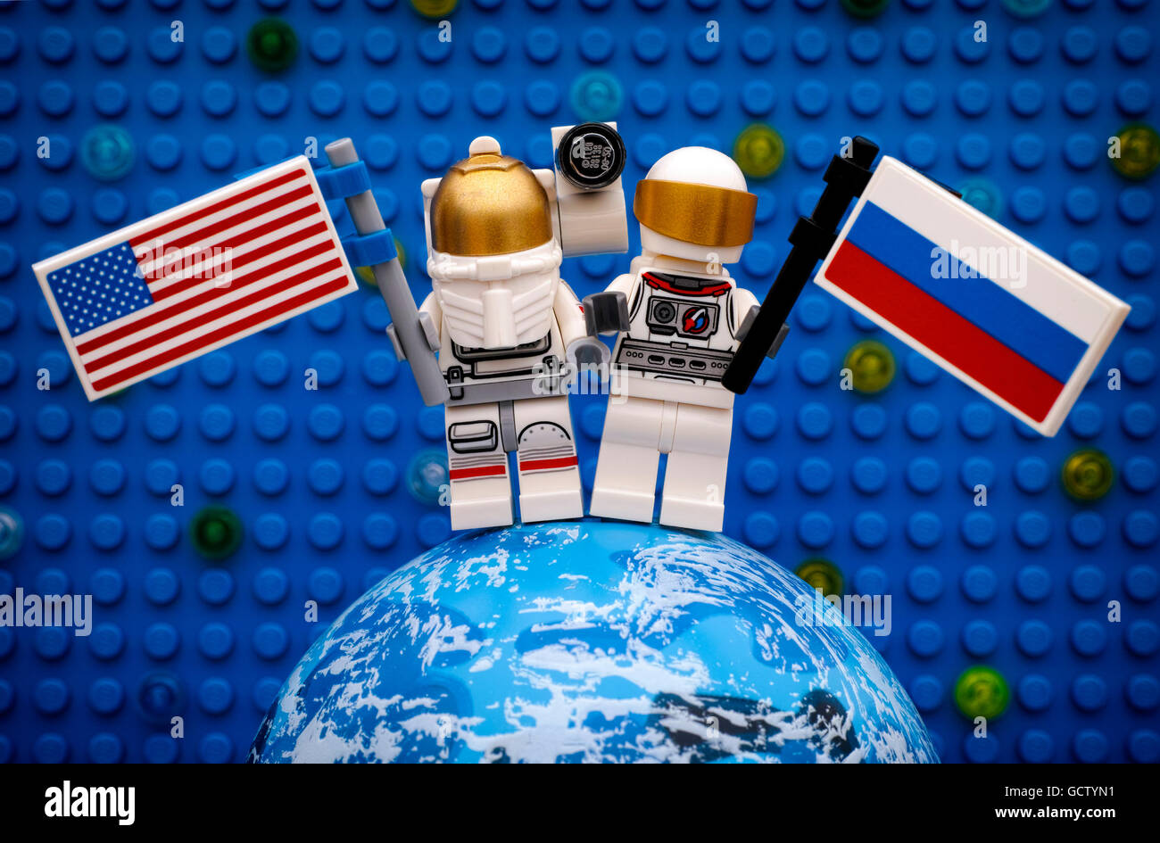 Two Lego spaceman minifigures with American and Russian flags stay on  planet against Lego blue baseplate with stars Stock Photo - Alamy
