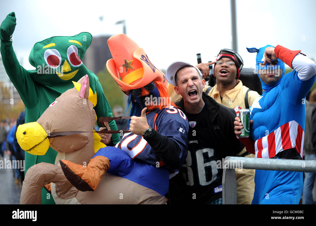 Fans in fancy dress pose for a photo outside Wembley Stadium Stock
