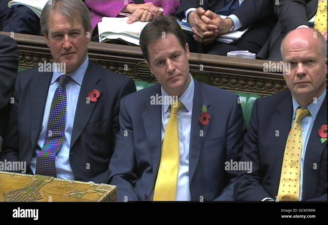 (left to right) Secretary of State for Northern Ireland Owen Paterson, Deputy Prime Minister Nick Clegg and First Secretary of State Secretary of State for Foreign and Commonwealth Affairs William Hague listen to Labour Party Deputy Leader Harriet Harman speak during Prime Minister's Questions in the House of Commons, London. Stock Photo
