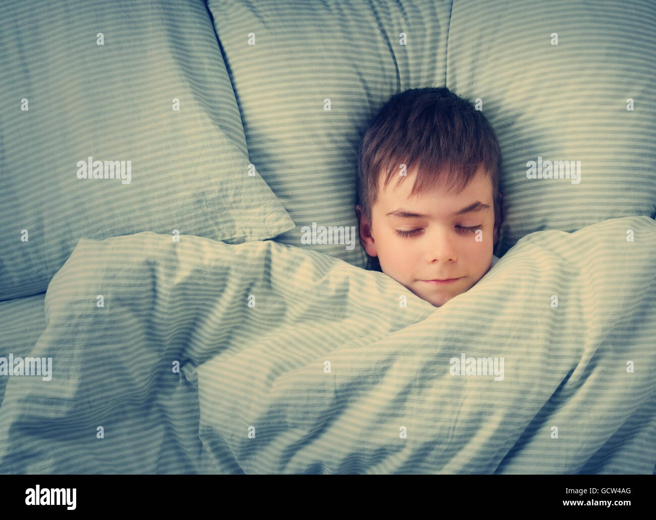 seven years old child in the bed Stock Photo