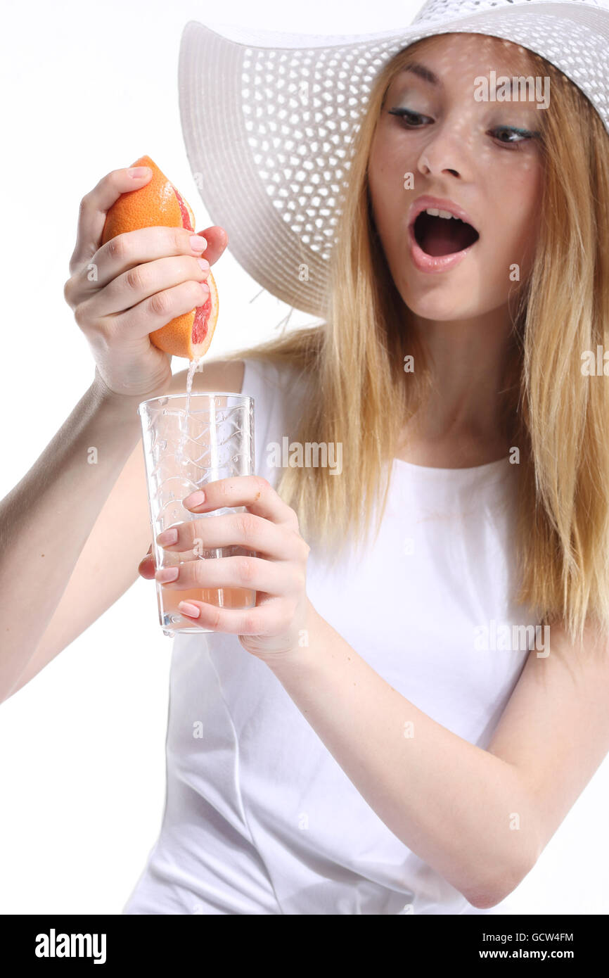 Girl making freshly squeezed grapefruit juice Stock Photo
