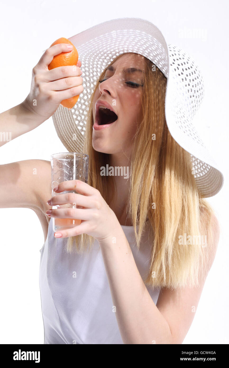 Girl making freshly squeezed grapefruit juice Stock Photo
