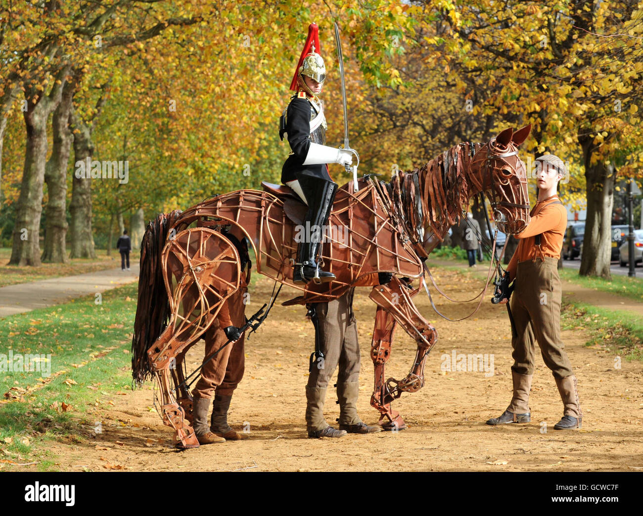 Aaran Reddish, a trooper with the Blues and Royals, sits astride 'Joey' the life-sized puppet star of hit west end production War Horse, in London's Hyde Park. Stock Photo