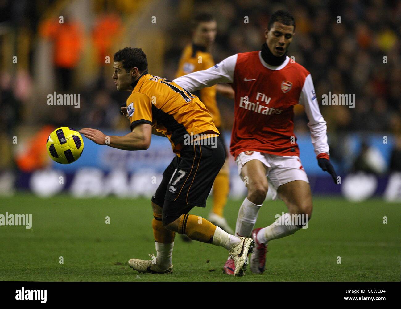 Wolverhampton Wanderers' Matthew Jarvis (left) and Arsenal's Marouane Chamakh collide as they battle for the ball Stock Photo