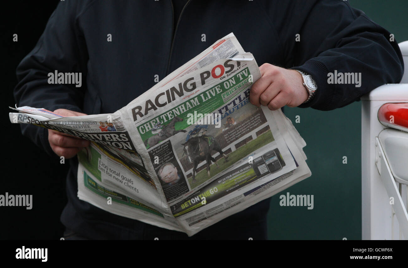 Horse Racing - The Open Sunday - Cheltenham Racecourse. A punter reads The Racing Post during the Open Sunday Day at Cheltenham Racecourse. Stock Photo