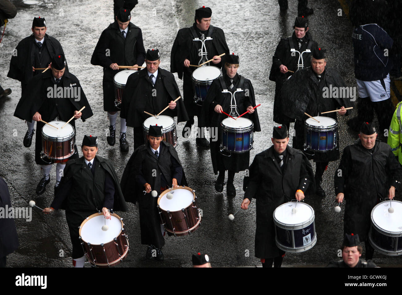 Bagpipe players lead the South Africa team bus as they arrive to crowds