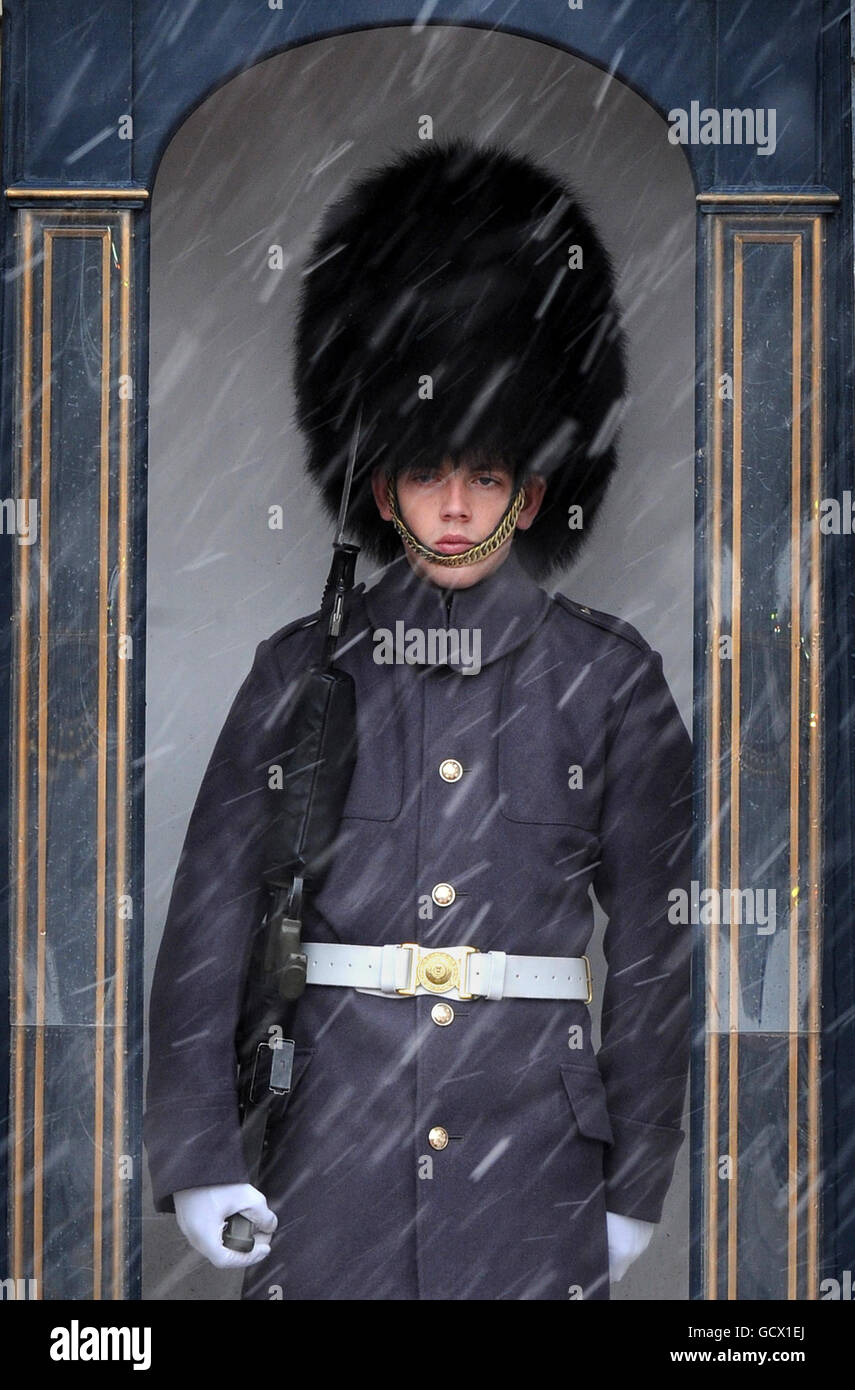 A Guardsman outside Buckingham Palace in London, as snow started to fall in the capital. Stock Photo