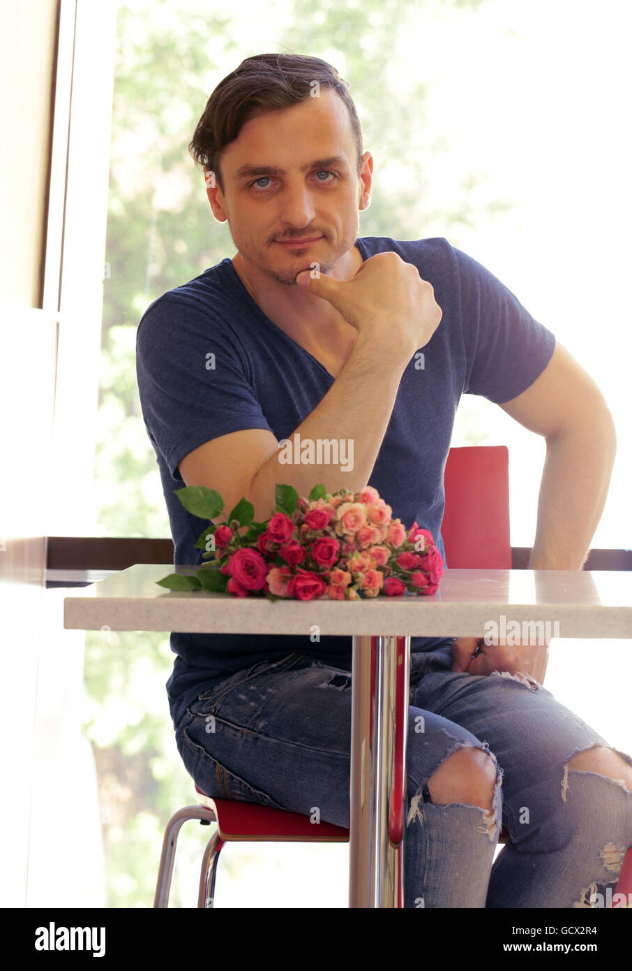 Man holding a bouquet of roses hi-res stock photography and images - Alamy