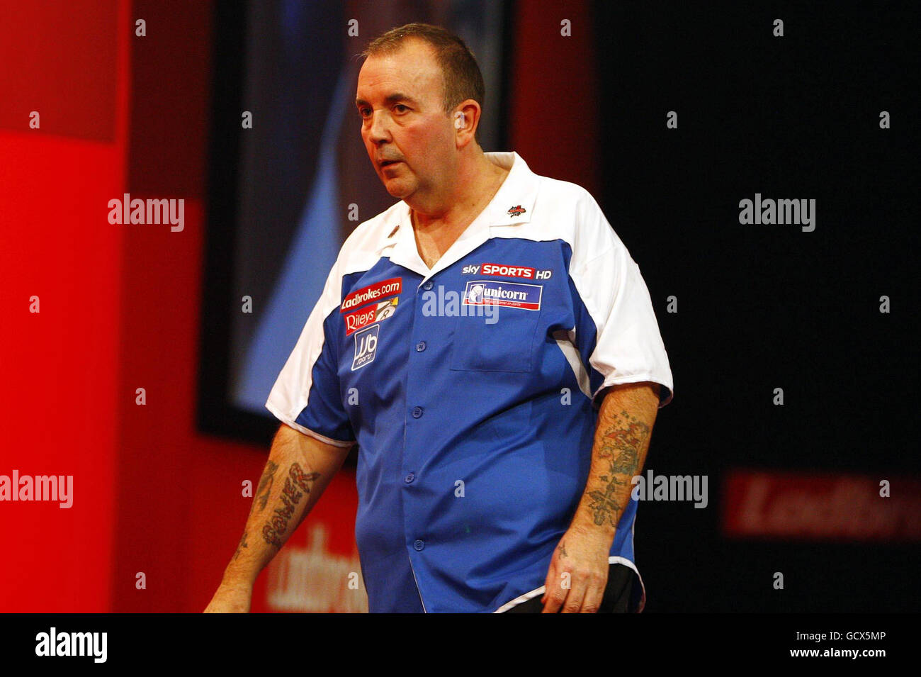 Phil Taylor reacts after beating Gary Mawson in their first round match during the