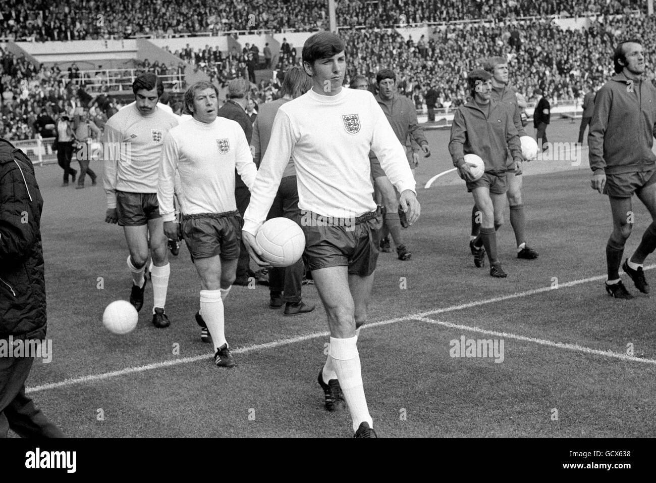 England's Martin Peters leads his team out at Wembley for his first match as captain. Following him are Ralph Coates and goalkeeper Gordon Banks. Stock Photo