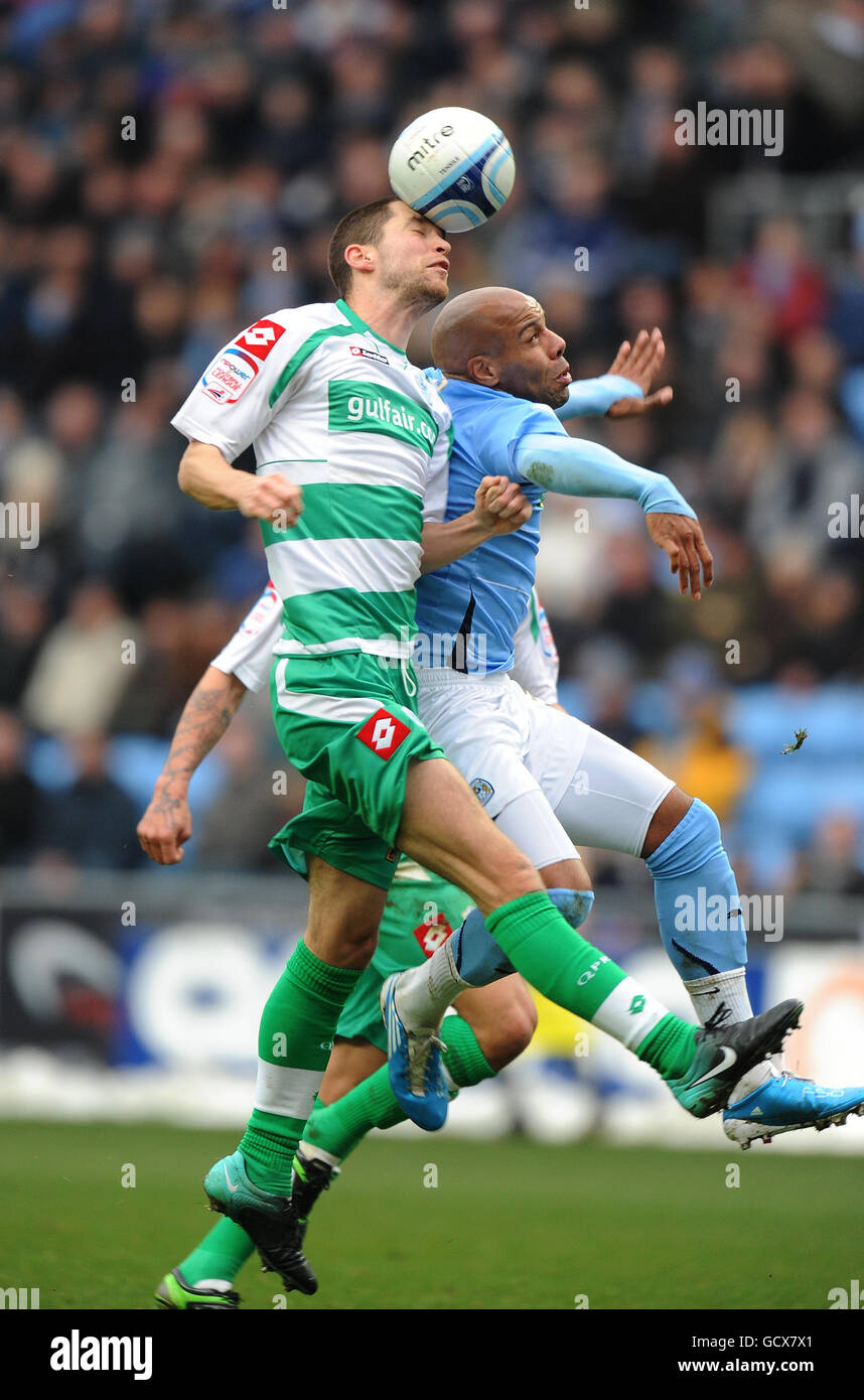 Coventry City's Marlon King is beaten to the ball by Queens Park Rangers' Matthew Connolly (left) during the npower Championship match at the Ricoh Arena, Coventry. Stock Photo