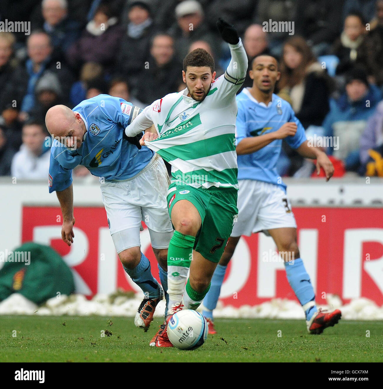 Coventry City's Lee Carsley pulls back Queens Park Rangers' Adel Taarabt (centre) during the npower Championship match at the Ricoh Arena, Coventry. Stock Photo