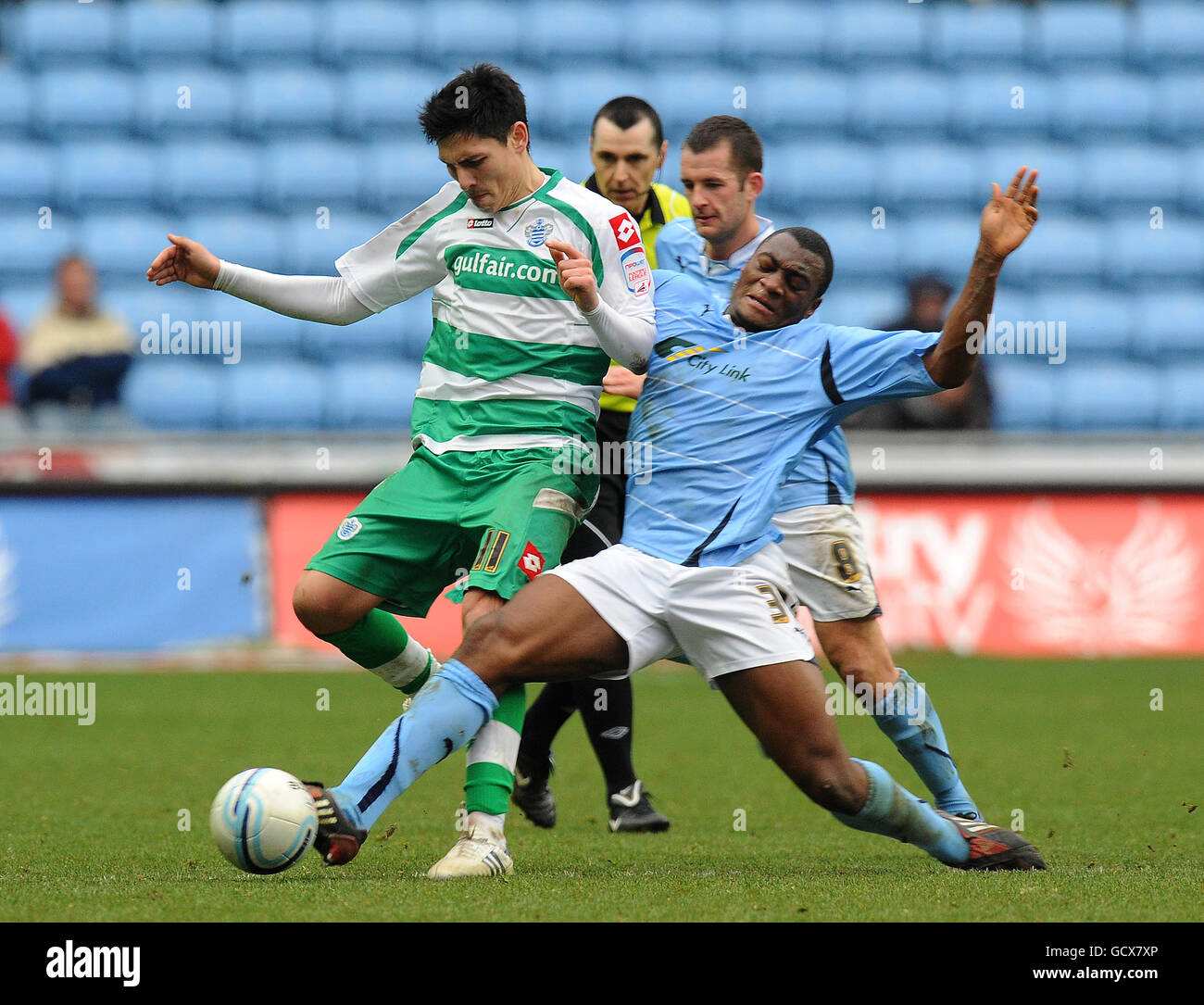 Coventry City's Nathan Cameron tackles Queens Park Rangers' Alejandro Faurlin (left) during the npower Championship match at the Ricoh Arena, Coventry. Stock Photo