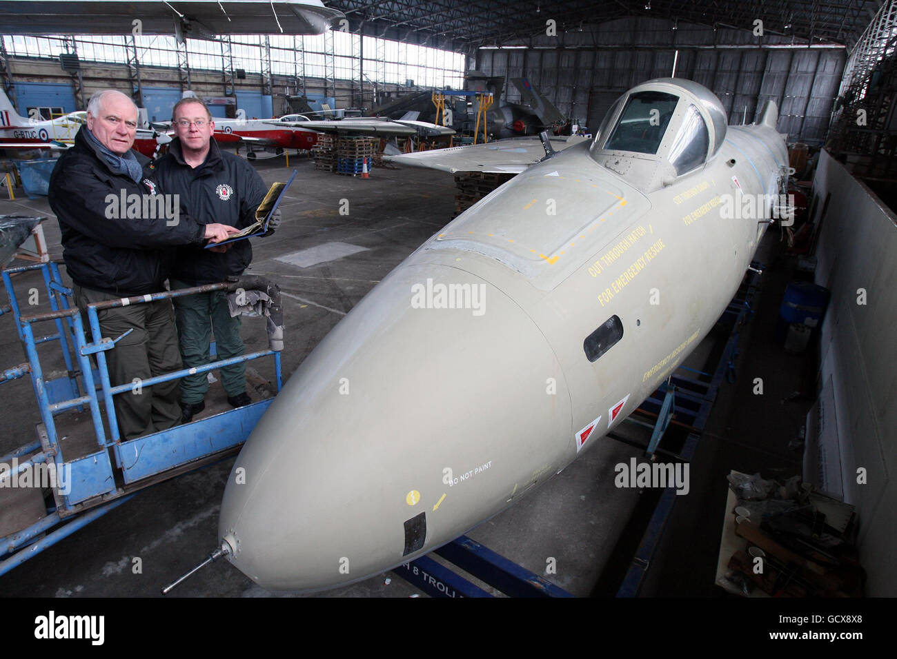Ray Burrows (left) and Malcolm Deeley from the Ulster Aviation Society in the nose of the Canberra PR9 that the volunteers are reassembling the aircraft at the former Maze Prison at Long Kesh, near Lisburn, Co.Antrim. Stock Photo