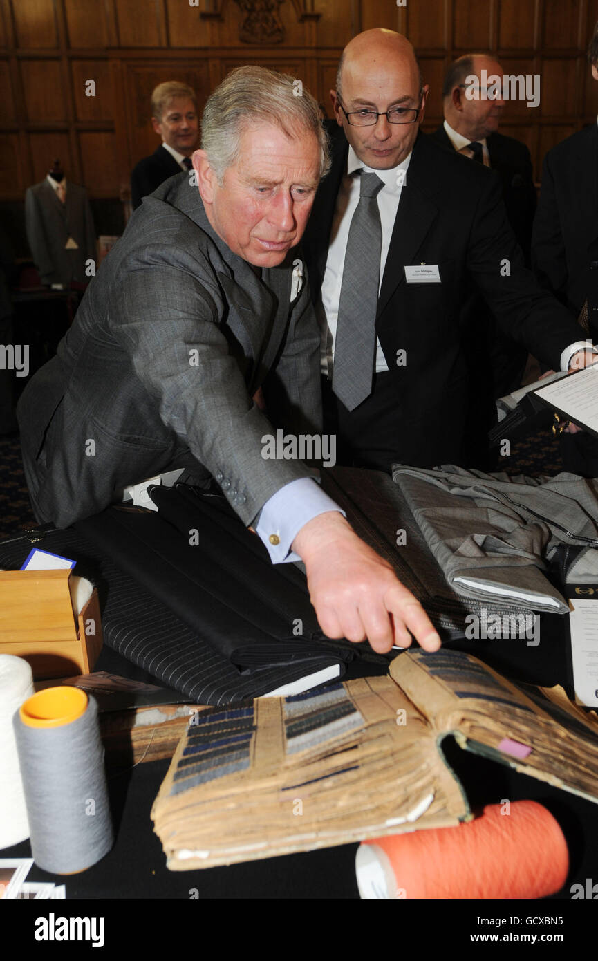 The Prince of Wales looks through an archive sample book of fabrics