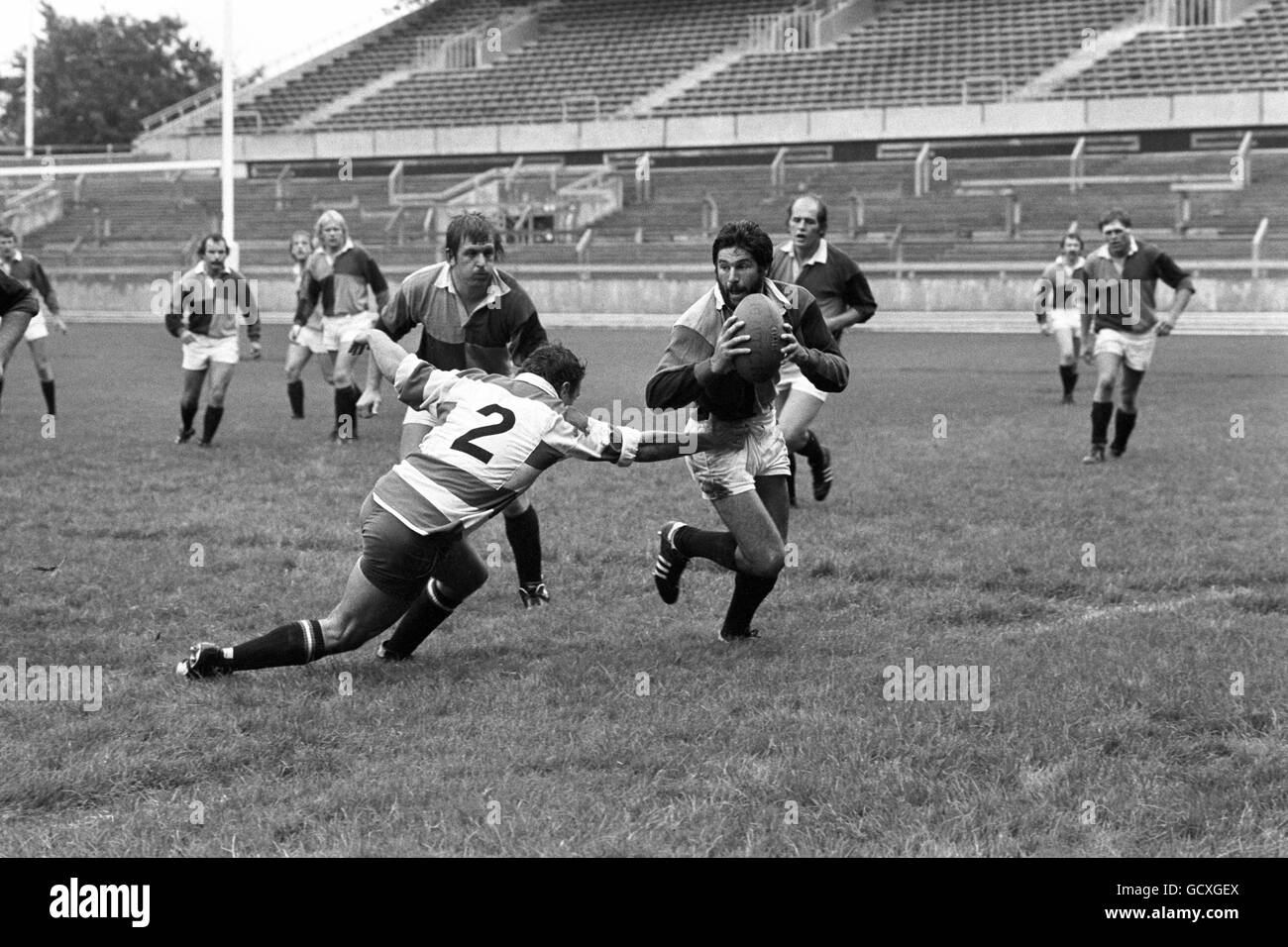 Gloucester captain S Mills dives in to tackle Harlequins J Gilmer Stock Photo