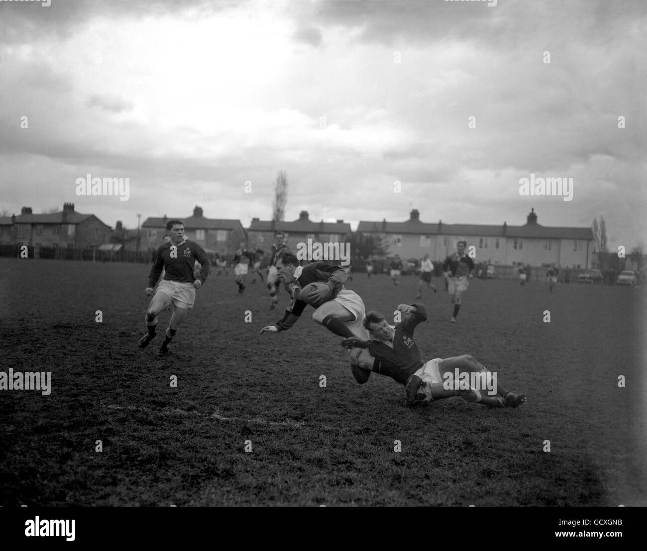 Harlequins H Eden is tackled by Capt. MHS Heath of the Army Stock Photo