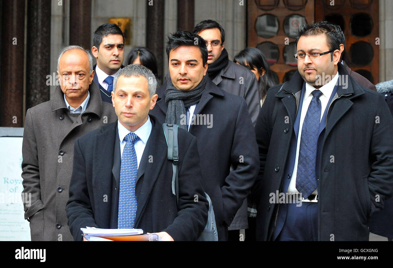 Solicitor Andrew Katzen is followed by relatives (names not known) of his client Shrien Dewani before he reads a statement on their behalf, outside the Royal Courts of Justice, London. Stock Photo