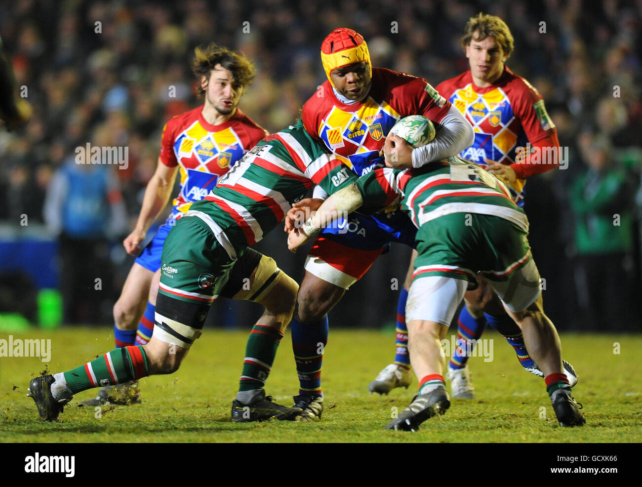 Leicester Tigers' Criag Newby and Martin Castrogiovanni (right) tackle USA Perpignan's Robins Tchale-Watchou during the Heineken Cup match at Welford Road, Leicester. Stock Photo