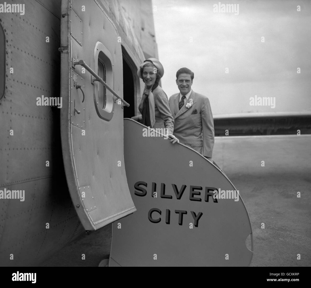 The Honorable Gerald Lascelles, younger son of the Princess Royal and cousin of the Queen, with his bride Angela Dowding, boarding a Silver City air freighter for Le Touquet, on the first stage of their motoring honeymoon on the Continent. Stock Photo