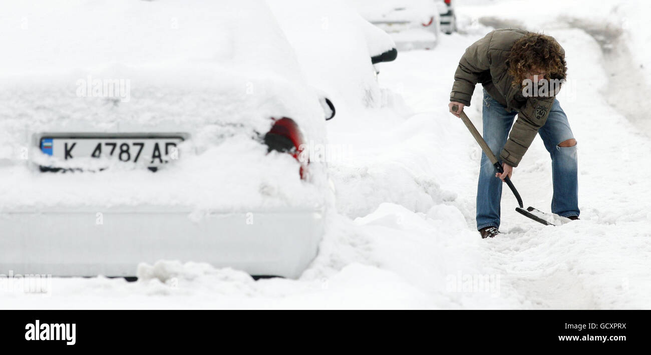 A man clears snow in Edinburgh as the big freeze tightened its grip on the nation. Stock Photo