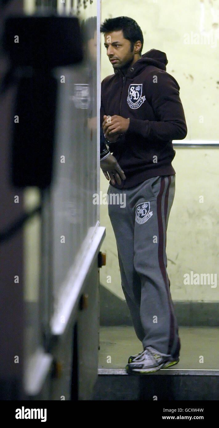 Shrien Dewani is escorted to a prison van as he leaves City of Westminster Magistrates Court, in Westminster, London. The British newlywed, accused of hiring a hitman to murder his bride, was remanded in custody tonight as the South African authorities fought to extradite him. Stock Photo