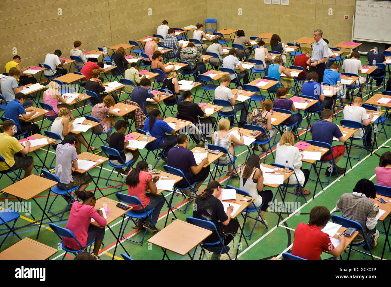 A-level students sit an A-level maths exam inside a sports hall Stock Photo