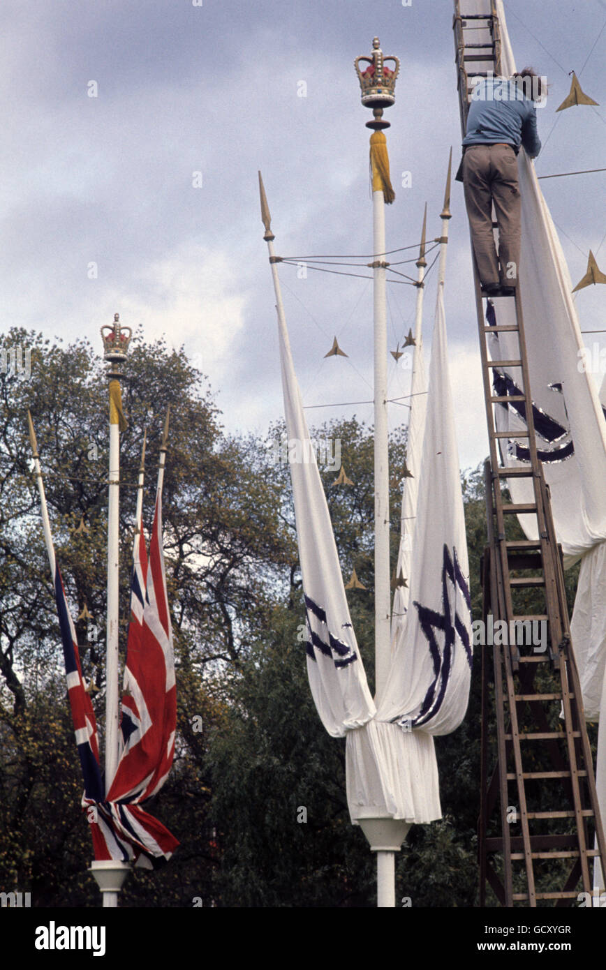 Special decorations, some of them bearing the initials A and M, being erected on The Mall in readiness for the royal wedding. Stock Photo