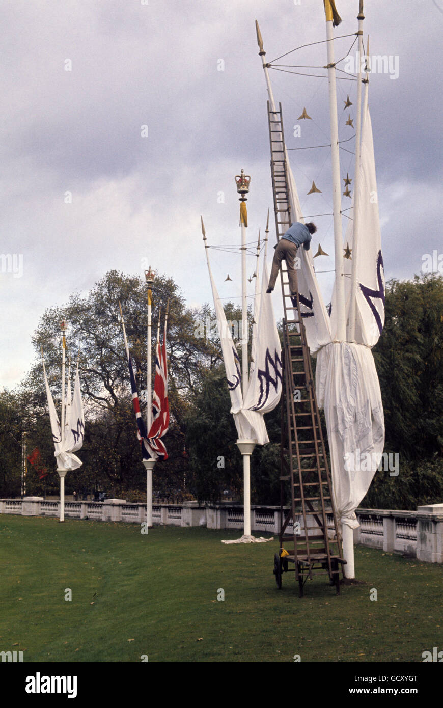 Special decorations, some of them bearing the initials A and M, being erected on The Mall in readiness for the royal wedding. Stock Photo