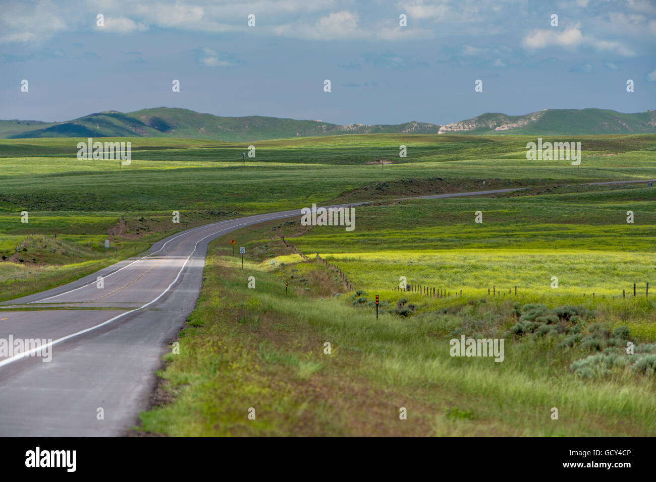 A rural highway leads into the distance. Stock Photo