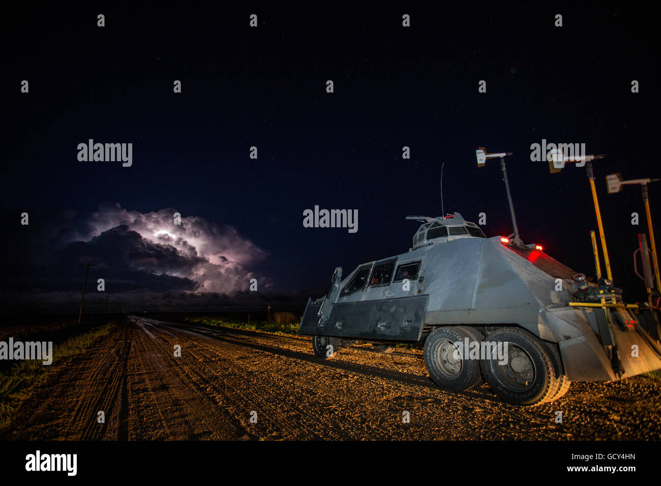 The storm chasers of the TIV 2 or 'Tornado Intercept Vehicle 2' prepare to drive towards a tornadic supercell at night. Stock Photo