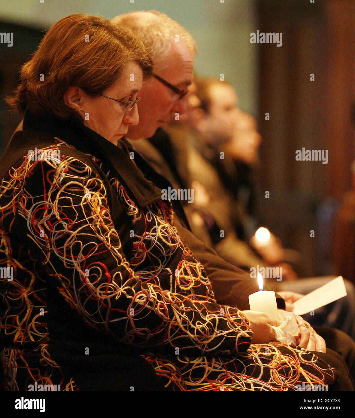 Parents and family members hold candles to remember their children who died from Sudden Cardiac Death, at an annual service held in Monkstown Church of Ireland, in Dublin. Stock Photo