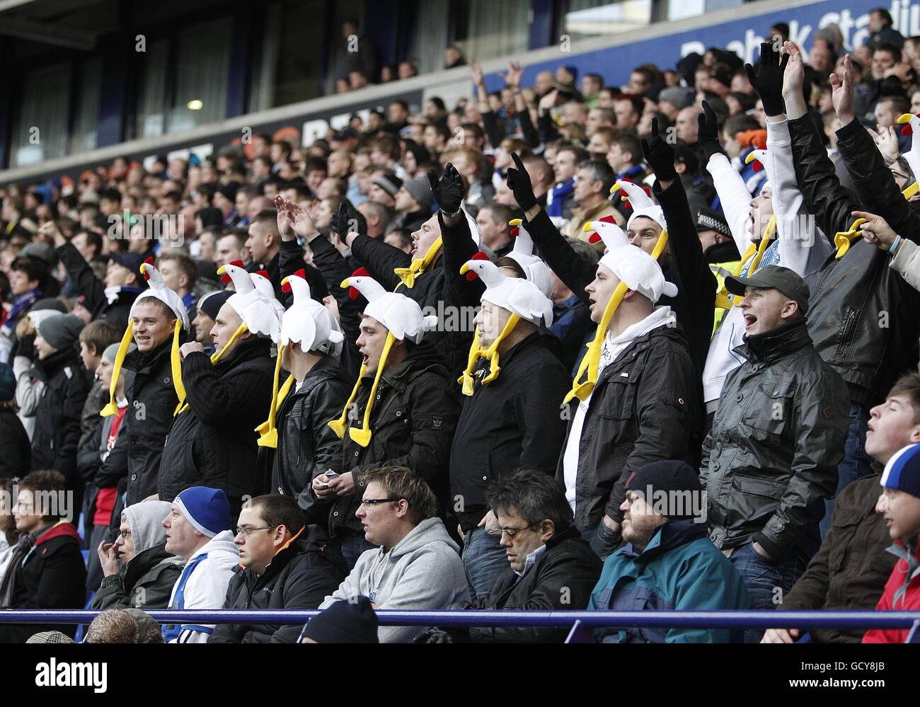 Soccer - Barclays Premier League - Bolton Wanderers v Blackburn Rovers - Reebok Stadium. Blackburn Rovers fans in the stands with comical hats Stock Photo