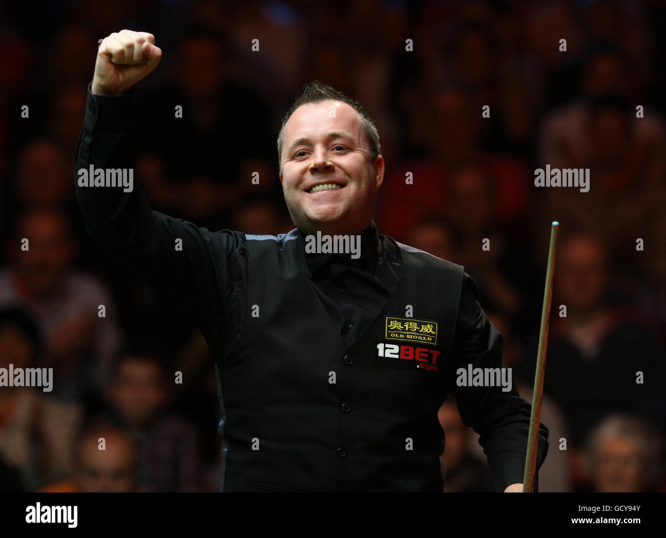 Scotland's John Higgins punches the air as he celebrates winning the final against Wales' Mark Williams 10-9 during the 12Bet.Com UK Championships at the Telford International Centre, Telford. Stock Photo