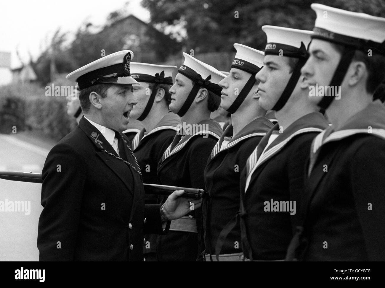 Chief Petty Officer Philip Greenaway issuing orders to some of the Royal Navy sailors who will line the route for the wedding of Prince Charles and Lady Diana Spencer. Some 250 men are being trained for the event at HMS Excellent, Whale Island, Portsmouth. Stock Photo