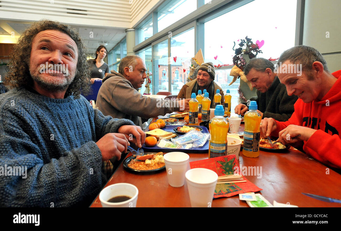 (from left) Dave Camacho, Ron Winder, Polish Bernard, Paul Waldron and Dave Walker eat a hot cooked breakfast, at the Crisis at Christmas centre for the homeless, in Docklands east London, this morning. Stock Photo