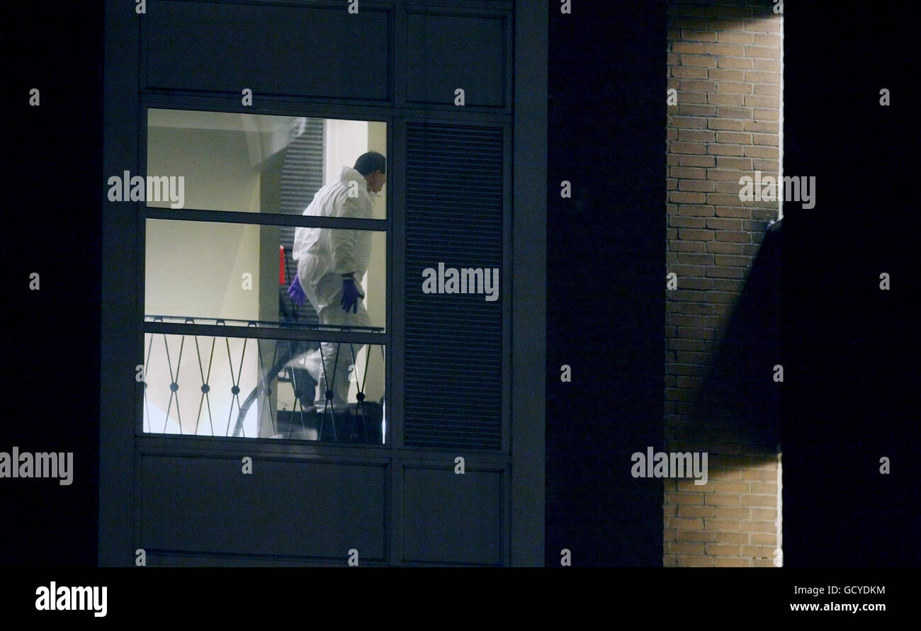 Forensics officers work in the stairwell of Heron House, on the Pelican Estate, in Peckham, south east London, where officers discovered a male youth, suffering a gunshot wound. Stock Photo