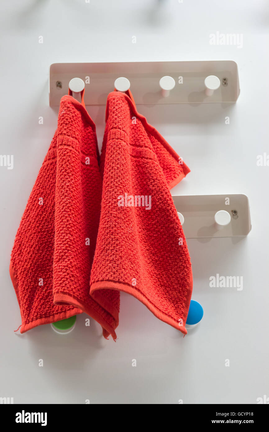 Red towel hangs in a bathroom Stock Photo