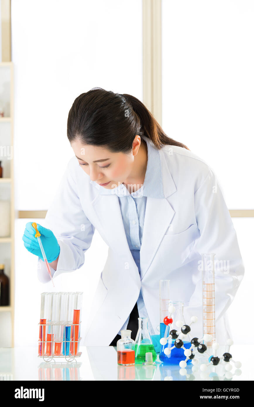 Young asian scientist pipetting in life science in laboratory with gloves Stock Photo