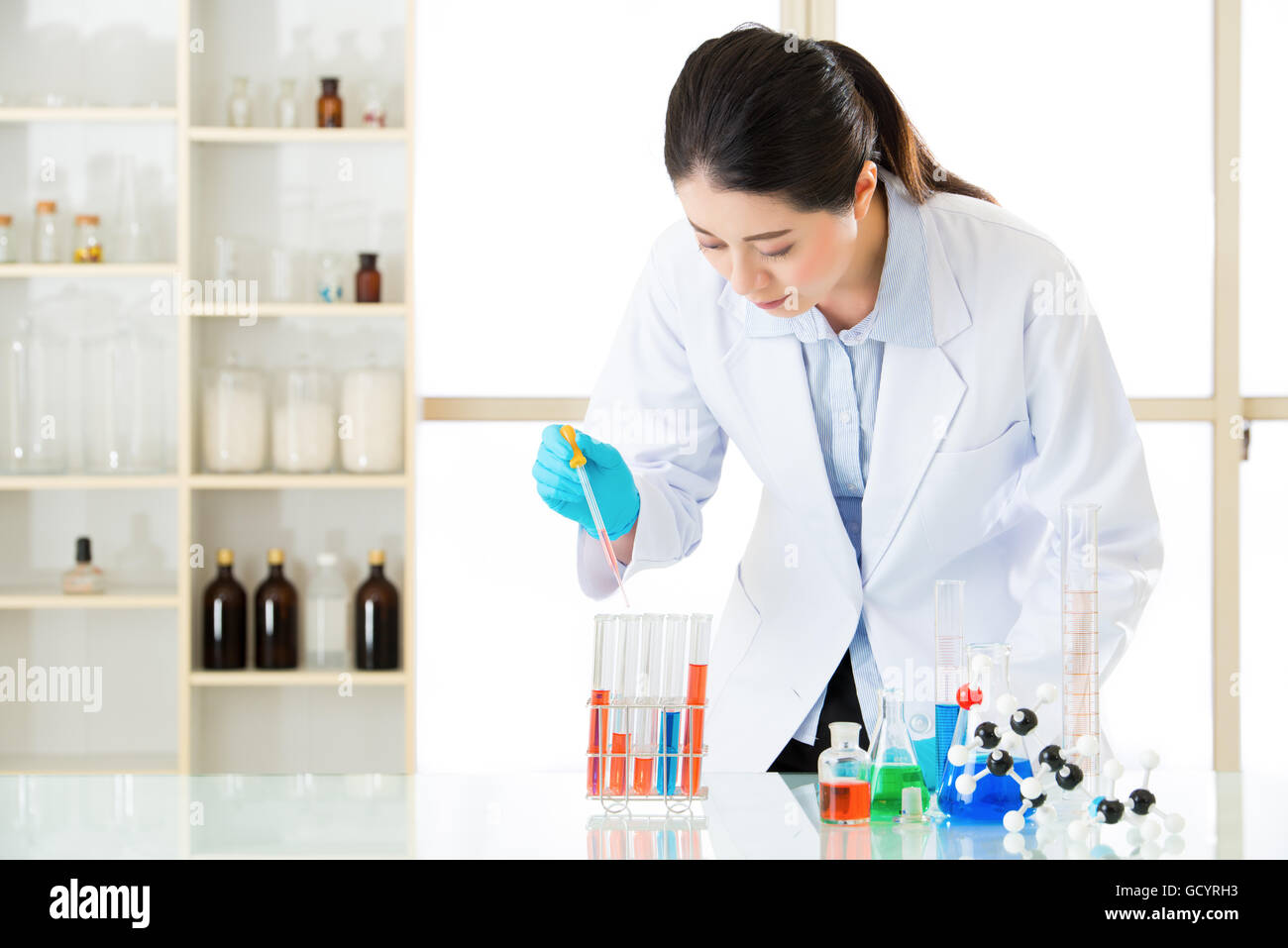 Young asian scientist know the results are conclusive in laboratory with gloves Stock Photo