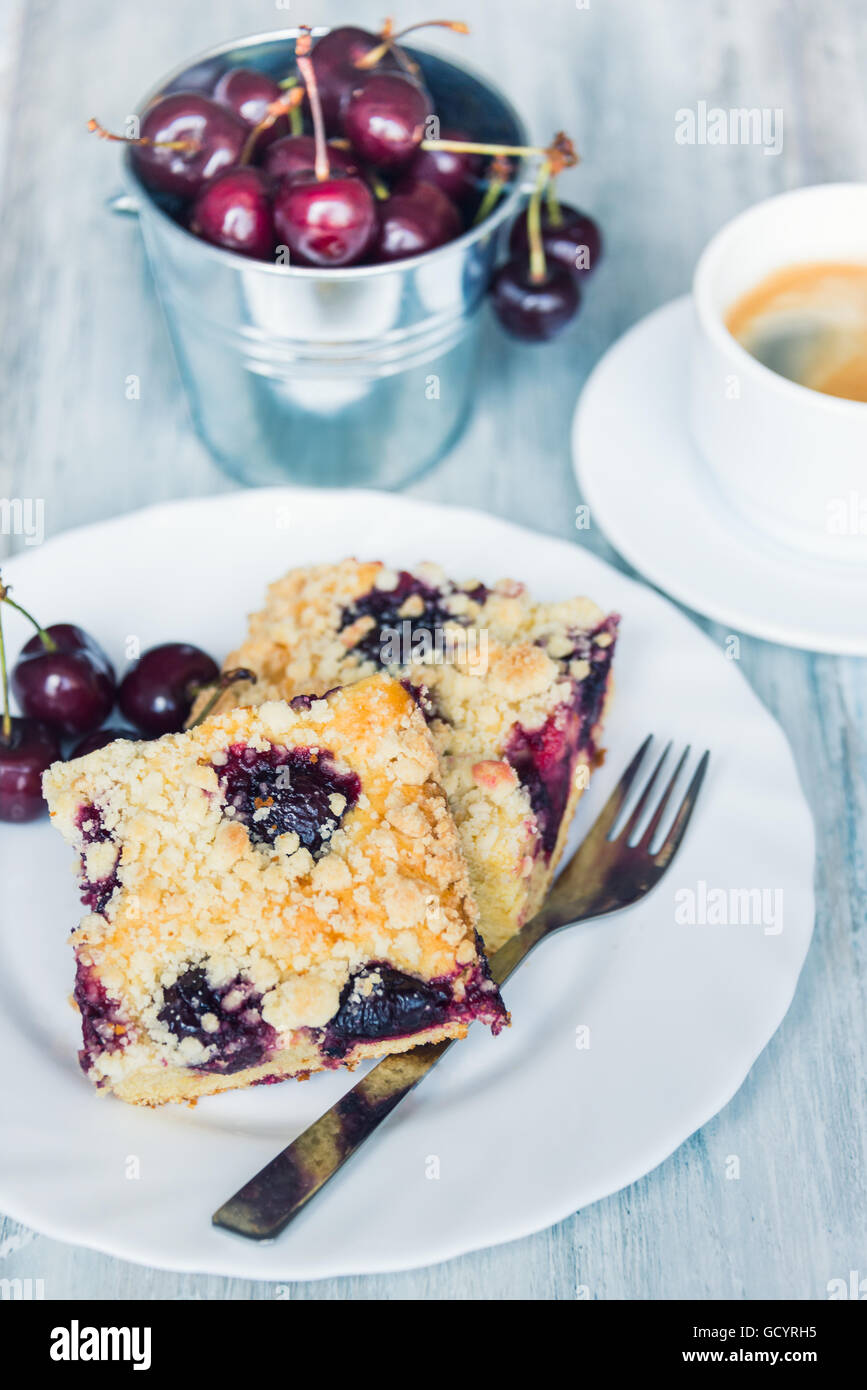 Slices of home made butter cherry cake with crumble topping Stock Photo